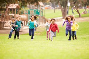  Children Playing Outside on the Grass