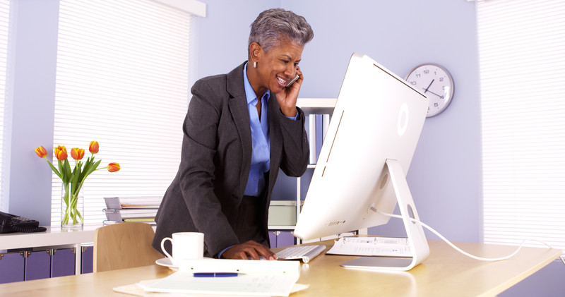 Woman standing at a desk compared to sitting